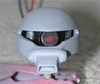La testa dello Zaku montata e colorata di grigio con all'interno l'occhio spento, vista frontalmente